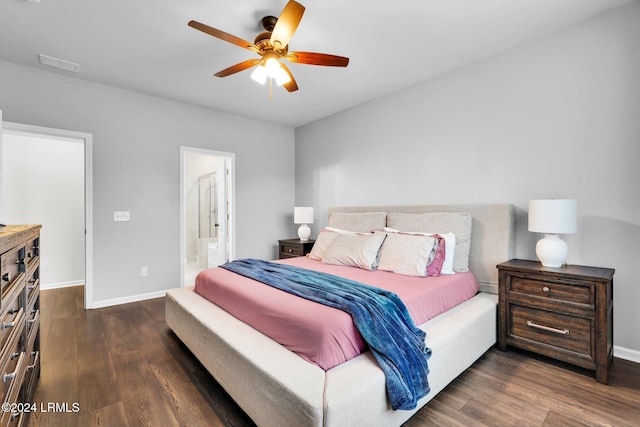 bedroom featuring ceiling fan, dark wood-type flooring, and ensuite bath