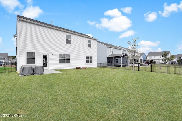 back of property featuring a yard and a patio area