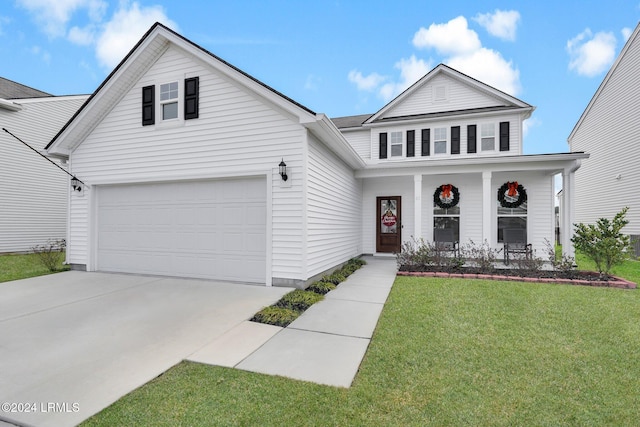 view of property featuring a garage, a front yard, and covered porch