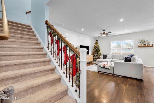 living room featuring hardwood / wood-style flooring and ceiling fan