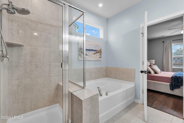 bathroom featuring ceiling fan, tile patterned floors, plus walk in shower, and a wealth of natural light