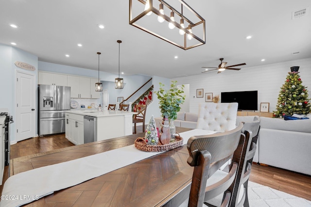 dining room with ceiling fan, light hardwood / wood-style floors, and sink