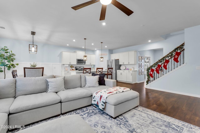 living room featuring hardwood / wood-style floors and ceiling fan