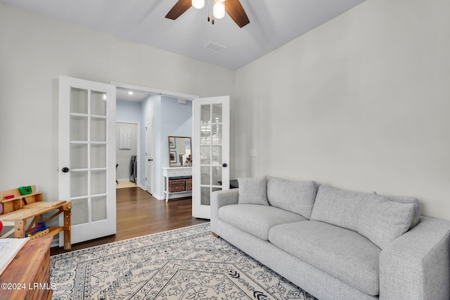 living room with ceiling fan, dark hardwood / wood-style flooring, and french doors