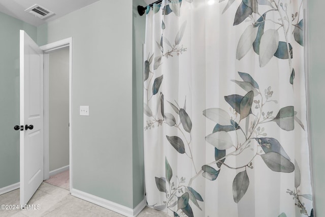 bathroom featuring tile patterned floors and walk in shower