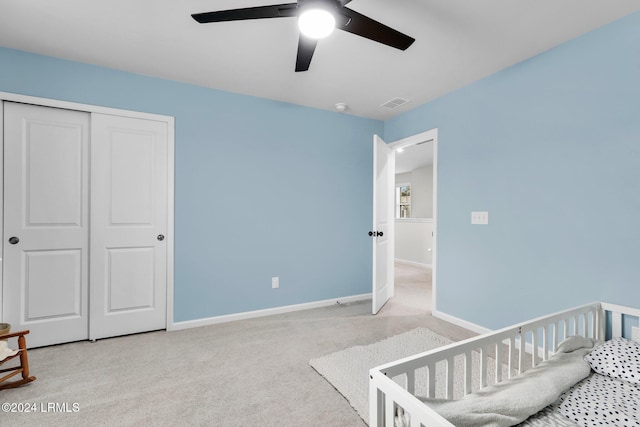 carpeted bedroom with a closet and ceiling fan