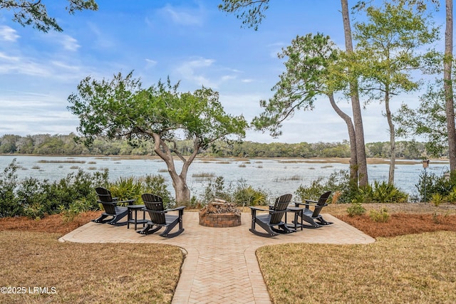 view of patio / terrace with an outdoor fire pit and a water view