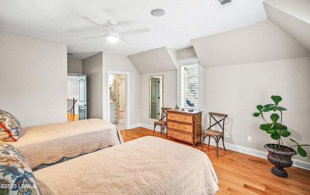 bedroom featuring light wood-style floors, lofted ceiling, visible vents, and baseboards