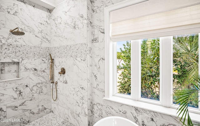 full bathroom featuring a soaking tub and a tile shower