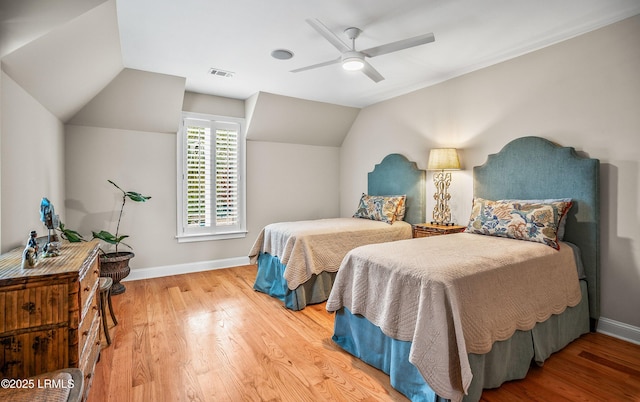 bedroom with wood finished floors, visible vents, and baseboards