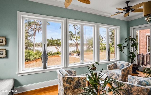 sunroom featuring ceiling fan