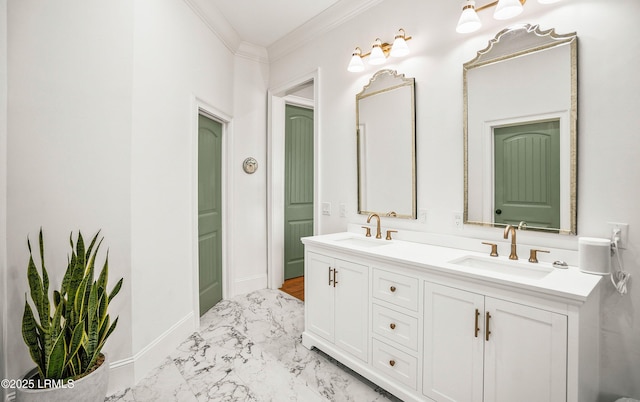 bathroom featuring double vanity, marble finish floor, crown molding, and a sink