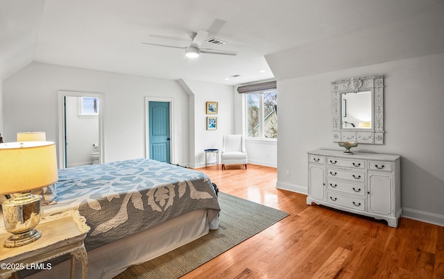 bedroom with visible vents, a ceiling fan, connected bathroom, light wood-type flooring, and baseboards