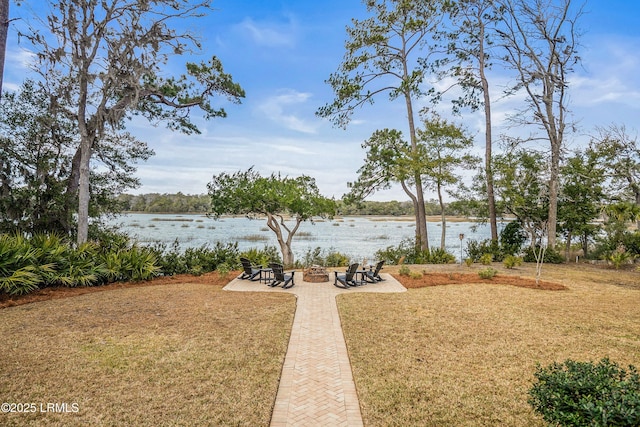 view of yard with a water view and a patio