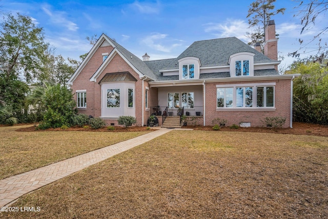 view of front of house featuring crawl space, covered porch, brick siding, and a front yard