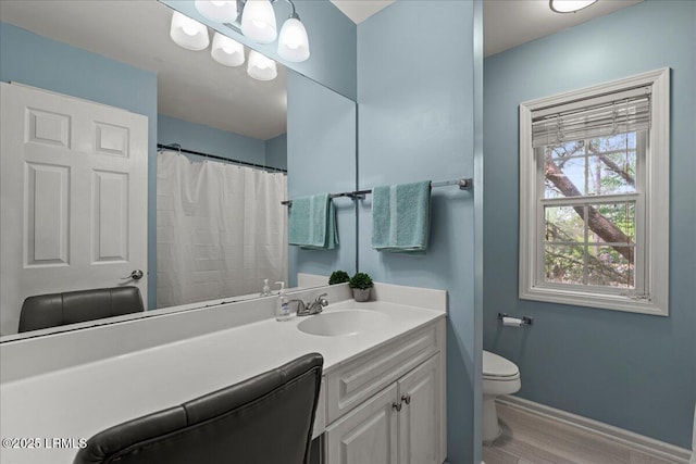 56 Timbercrest Cir, Hilton Head Island, SC 29926 - bathroom with baseboards, wood finished floors, toilet, and vanity
