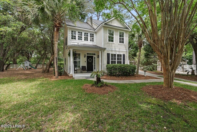 56 Timbercrest Cir, Hilton Head Island, SC 29926 - traditional-style house with a front yard and a playground