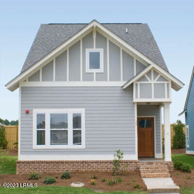 tudor-style house with a front yard