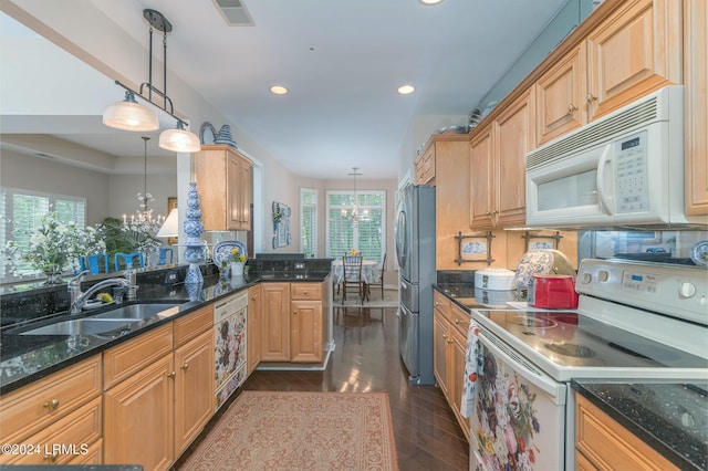 kitchen featuring white appliances, decorative light fixtures, a chandelier, and sink