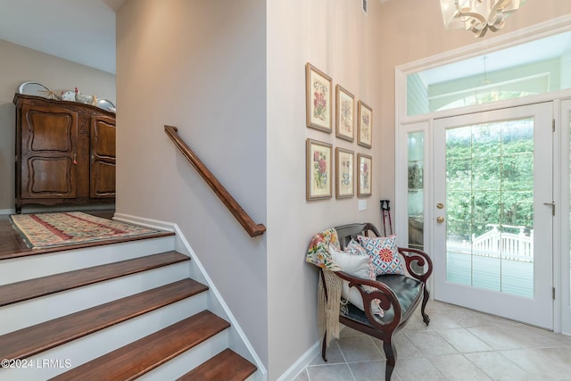 entryway featuring a notable chandelier and light tile patterned floors