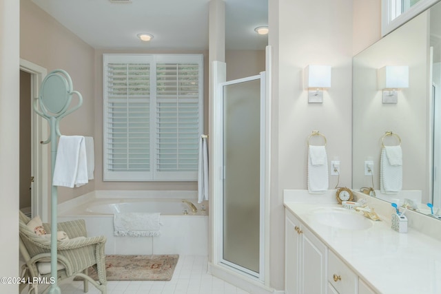 bathroom featuring vanity and shower with separate bathtub