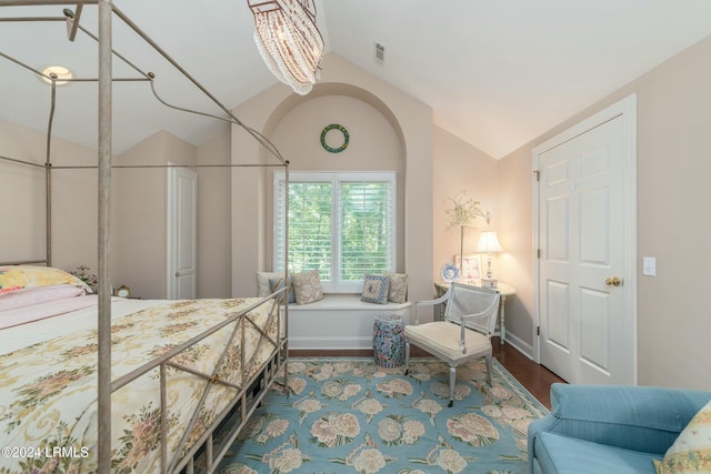 bedroom featuring lofted ceiling and hardwood / wood-style flooring