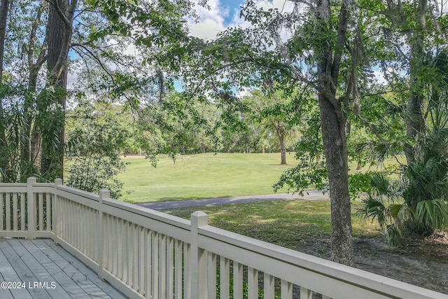 wooden deck with a lawn