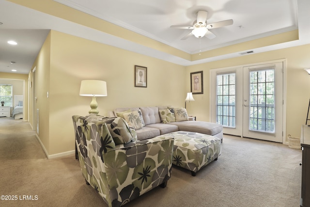 4924 Bluffton Pkwy Unit 18-202, Bluffton, SC 29910 - carpeted living room featuring crown molding, french doors, a ceiling fan, baseboards, and a tray ceiling