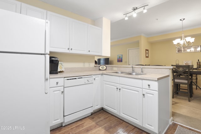 4924 Bluffton Pkwy Unit 18-202, Bluffton, SC 29910 - kitchen featuring white appliances, a peninsula, a sink, white cabinetry, and light countertops