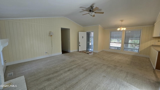 unfurnished living room featuring visible vents, crown molding, lofted ceiling, carpet floors, and ceiling fan with notable chandelier