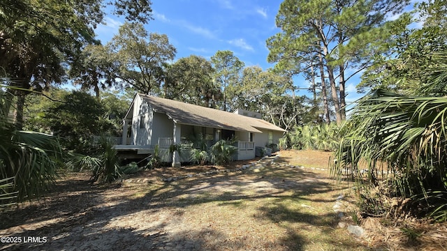 exterior space featuring a shingled roof