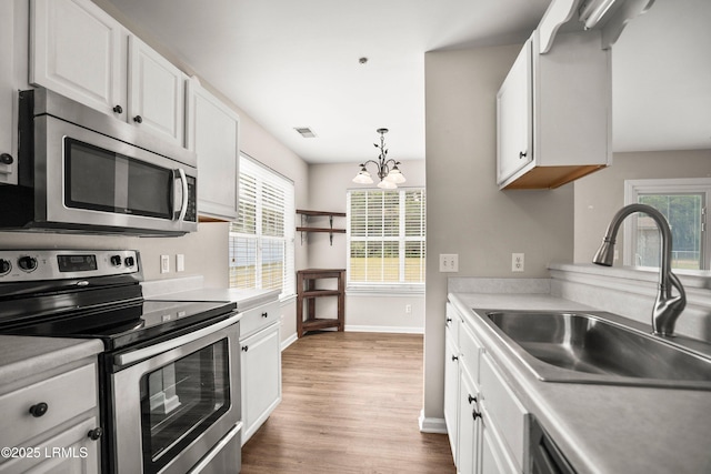 2718 Waddell Rd, Beaufort, SC 29902 - kitchen featuring a notable chandelier, appliances with stainless steel finishes, a sink, wood finished floors, and visible vents