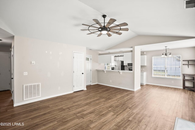 2718 Waddell Rd, Beaufort, SC 29902 - unfurnished living room featuring ceiling fan with notable chandelier, lofted ceiling, wood finished floors, and visible vents