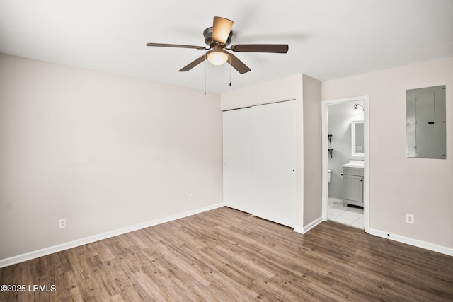 2718 Waddell Rd, Beaufort, SC 29902 - unfurnished bedroom with baseboards, electric panel, a closet, and wood finished floors