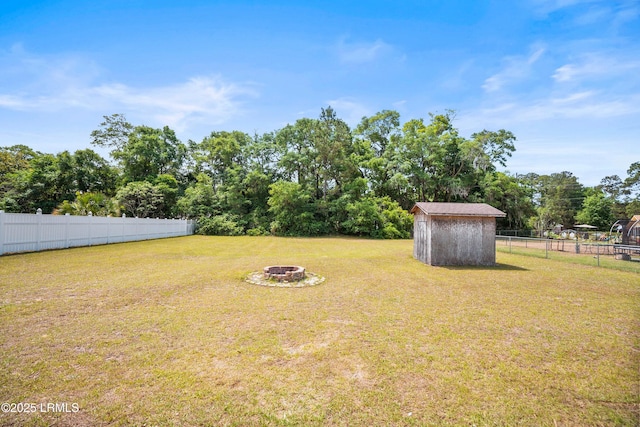 2718 Waddell Rd, Beaufort, SC 29902 - view of yard featuring a fenced backyard, an outdoor structure, an outdoor fire pit, and a shed
