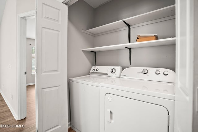 2718 Waddell Rd, Beaufort, SC 29902 - washroom featuring laundry area, baseboards, wood finished floors, and washing machine and clothes dryer