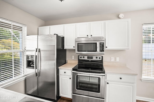 2718 Waddell Rd, Beaufort, SC 29902 - kitchen with light countertops, appliances with stainless steel finishes, and white cabinets