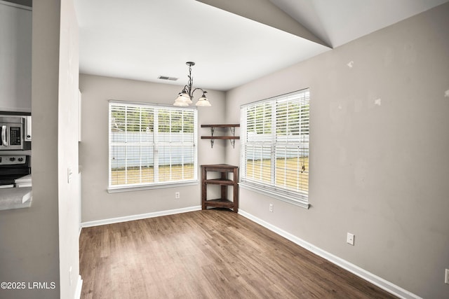 2718 Waddell Rd, Beaufort, SC 29902 - unfurnished dining area with baseboards, a notable chandelier, wood finished floors, and visible vents