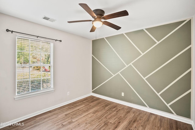 2718 Waddell Rd, Beaufort, SC 29902 - spare room with baseboards, visible vents, a healthy amount of sunlight, and wood finished floors