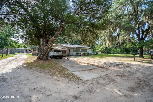 45 Youmans Dr, Ladys Island, SC 29907 - view of front of property featuring driveway, a carport, fence, and view of scattered trees