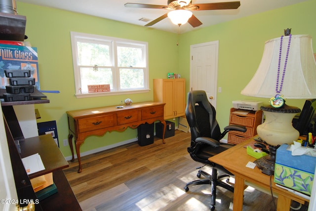 home office featuring ceiling fan and light hardwood / wood-style floors