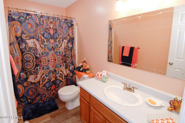 bathroom with vanity, hardwood / wood-style floors, toilet, and a shower with shower curtain