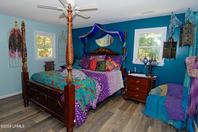 bedroom with ceiling fan and wood-type flooring