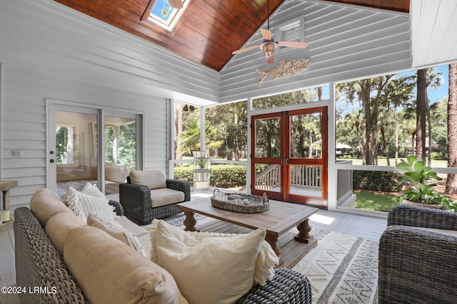 sunroom / solarium featuring wood ceiling, lofted ceiling with skylight, and ceiling fan