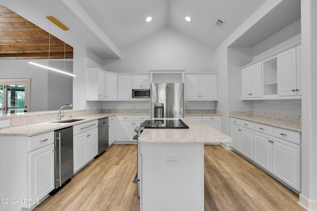 kitchen featuring sink, appliances with stainless steel finishes, white cabinets, pendant lighting, and backsplash