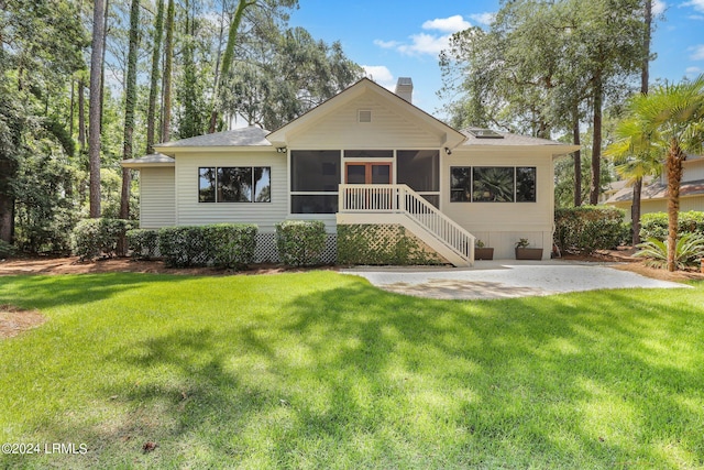 bungalow-style home featuring a front yard and a sunroom