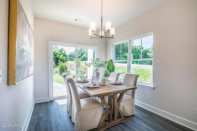 dining area with an inviting chandelier and dark hardwood / wood-style flooring