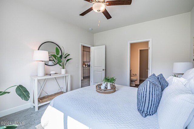 bedroom featuring ceiling fan, carpet flooring, and ensuite bath