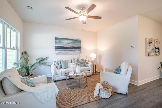 living room featuring dark hardwood / wood-style floors and ceiling fan