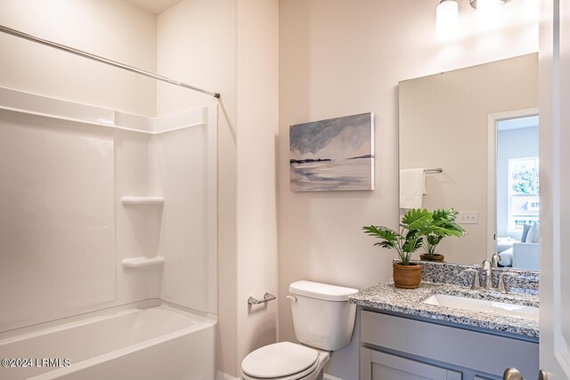 full bathroom featuring vanity, bathtub / shower combination, and toilet